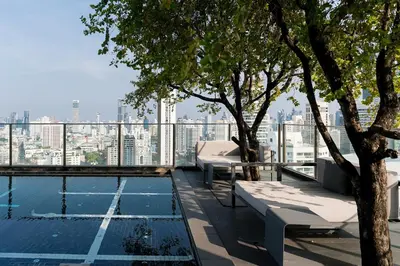 a swimming pool on the roof of a building at Lux Condo 2BR - 5 mins walk to BTS Phrom Phong in Bangkok