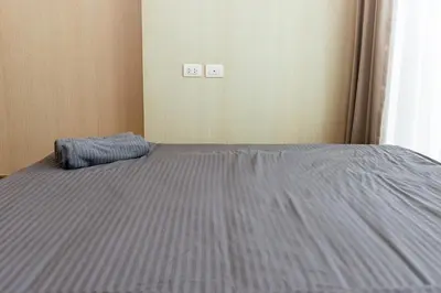 a bedroom with a bed with a blue blanket on it at Lux Condo 2BR - 5 mins walk to BTS Phrom Phong in Bangkok