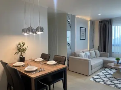 a dining room and living room with a table and chairs at Cozy style 2BR 2B near street food in city in Bangkok