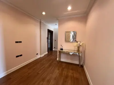 an empty hallway with a table and a mirror on the wall at Luxury Villa 4BR - 8 Mins to Thonglor BTS in Bangkok