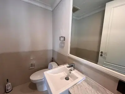 a bathroom with a white toilet and a sink at Luxury private swimming pool house for 10pax in Bangkok