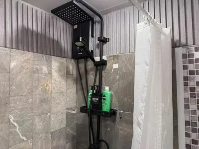 a shower in a bathroom with a shower at Cozy Studio near Train Night market & BKK Airport in Bangna