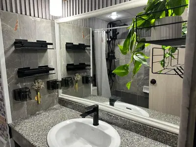 a bathroom with a sink and a mirror at Cozy Studio near Train Night market & BKK Airport in Bangna