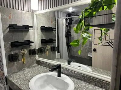 a bathroom with a sink and a mirror at Cozy Studio near Train Night market & BKK Airport in Bangna