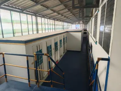 an empty hallway of a school building with windows at Worsakornrit Homestay in Bangkok