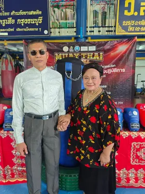 a man and a woman holding hands in a store at Worsakornrit Homestay in Bangkok