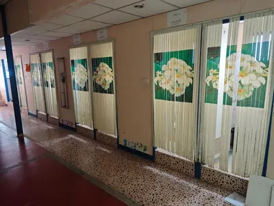 a row of lockers in a building with paintings on the walls at Worsakornrit Homestay in Bangkok