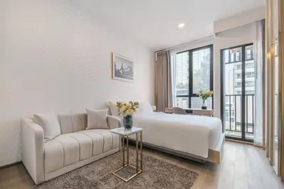 a hotel room with a bed and a couch at Hampton Residence Phayathai in Sathani Sam Sen