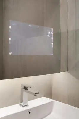 a bathroom with a white sink and a mirror at Hampton Residence Phayathai in Sathani Sam Sen