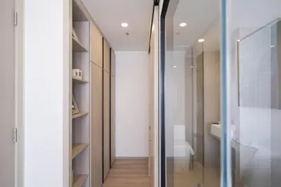 a walk in shower in a bathroom with a glass door at The Hampton Suites Bangna in Bangna