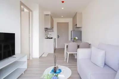 a living room with a white couch and a table at The Hampton Suites Bangna in Bangna