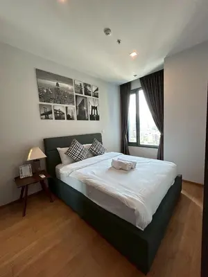 a bedroom with a large bed and a window at Thonglor BTS Prime Pool gym Netflix city in Bangkok