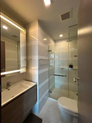 a bathroom with a shower and a toilet and a sink at Thonglor BTS Prime Pool gym Netflix city in Bangkok