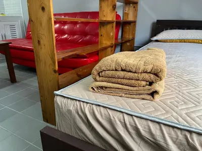 a bed with two towels sitting on top of it at Impact Arena C5 by Jintana in Thung Si Kan