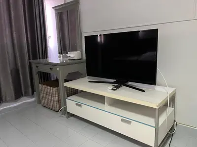a flat screen tv sitting on a white entertainment center at Impact Arena C5 by Jintana in Thung Si Kan