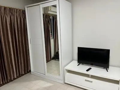 a living room with a television and a mirror at Impact Arena C5 by Jintana in Thung Si Kan