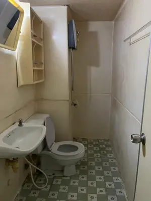 a small bathroom with a toilet and a sink at Impact Arena C5 by Jintana in Thung Si Kan