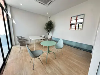 a meeting room with a table and chairs at Whiteinn - ไวท์อินน์ in Nonthaburi