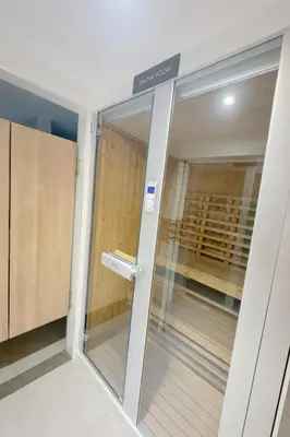 a walk in closet with a glass door at Bright & Green apartment on BTS Thonglor in Bangkok