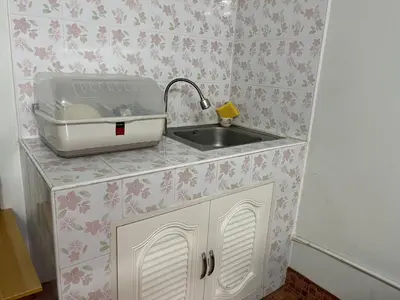 a kitchen counter with a sink and a toaster at Impact Arena C9 by Jintana in Thung Si Kan