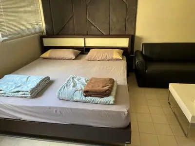 a bedroom with two beds with towels on them at Impact Arena C9 by Jintana in Thung Si Kan