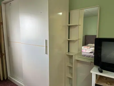 a white closet with a mirror and a television at Impact Arena C9 by Jintana in Thung Si Kan