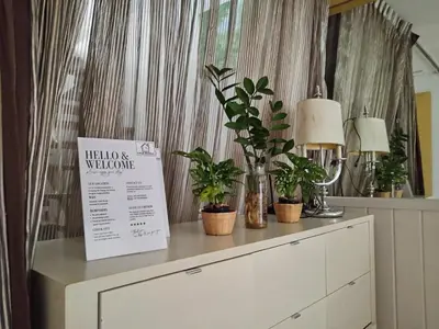 a dresser with potted plants on top of it at Casa Nicola BKK in Ban Na Song