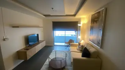 a living room with a couch and a tv at Sawasdee Bangkok Condo Modern 2BR BTS Srinakarin38 connect Sukhumvit Route 20mins Aiport and 15mins Sukhumvit Line in Bangna