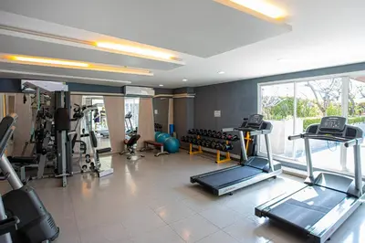 a gym with treadmills and exercise equipment in a room at Dazzle Residence ByPinny2 in Bangkok