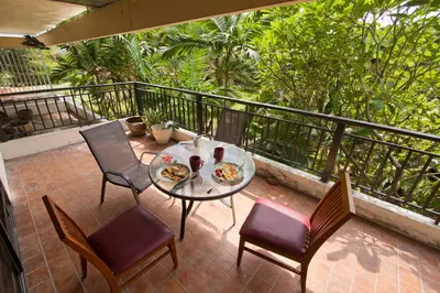 a patio with a table and chairs on a balcony at Big 3 bedroom apartment Asoke in Bangkok