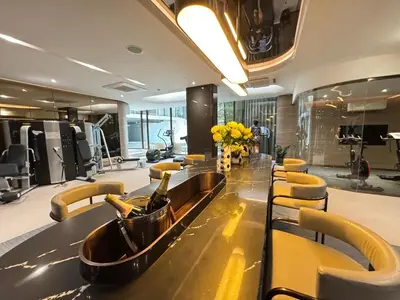 a bathroom with a long table with a bottle of champagne at Fynn Bangkok Asoke Condo in Bangkok