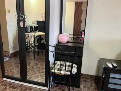 a black chair sitting in front of a mirror at Impact Arena C4 by Jintana in Ban Bang Phang