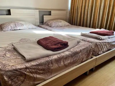 two beds with towels sitting on top of them at Impact Arena C4 by Jintana in Ban Bang Phang