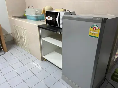 a kitchen with a refrigerator and a microwave at Impact Arena C3 by Jintana in Ban Bang Phang