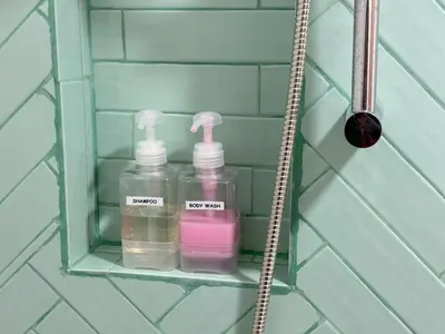 a shelf with two bottles on it in a bathroom at Armass Residence in Bangna