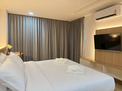 a hotel room with a bed with towels on it at Armass Residence in Bangna