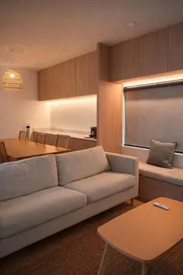 a living room with a couch and a table at Feel Private Pool Villa in Ban Lam Praya Phai Rua