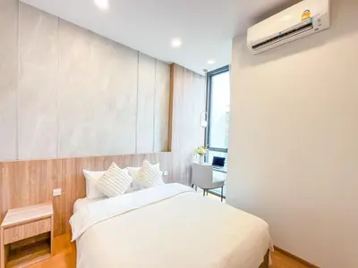 a bedroom with a white bed and a window at Luxe City Condo in Central Bangkok in Pratunam