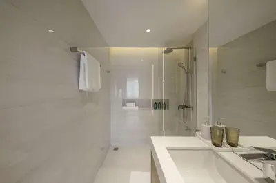 a white bathroom with a sink and a shower at Bhumidol Home near Don Muang Airport in Lak Si