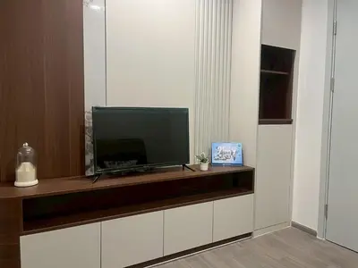 a flat screen tv sitting on top of a cabinet at Wutthakat new room in Bangkok