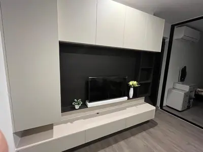 a living room with a tv on a wall at Wutthakat new room in Bangkok