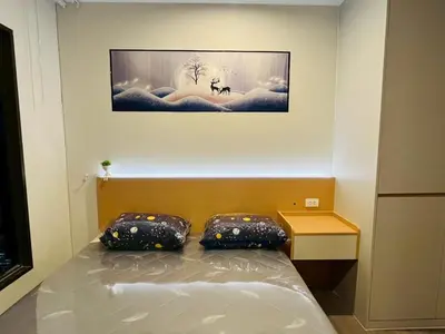 a bedroom with a bed with two pillows on it at Wutthakat new room in Bangkok