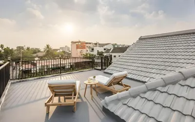 a balcony with two chairs and a table on a roof at Bangkoks most beautiful modern villa centre in Bangkok