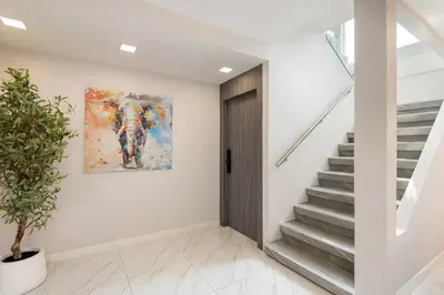 a staircase in a house with a painting on the wall at Bangkoks most beautiful modern villa centre in Bangkok