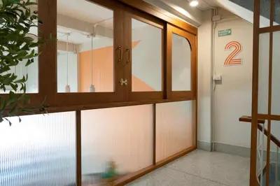 a room with a glass door with the number two at Sadhu10BedBake in Bangkok