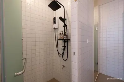a bathroom with a shower with a shower head at Sadhu10BedBake in Bangkok