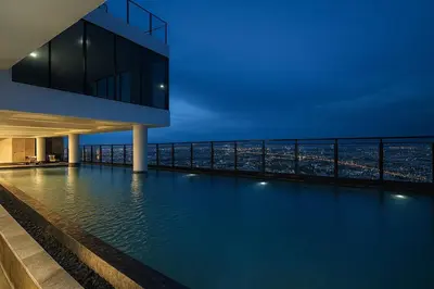 a swimming pool on the roof of a building at High-Ceiling Loft Suite Rama 9 Design Apartment in Bangkok