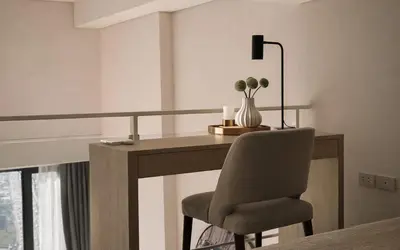 a desk with a chair and a lamp in a room at High-Ceiling Loft Suite Rama 9 Design Apartment in Bangkok