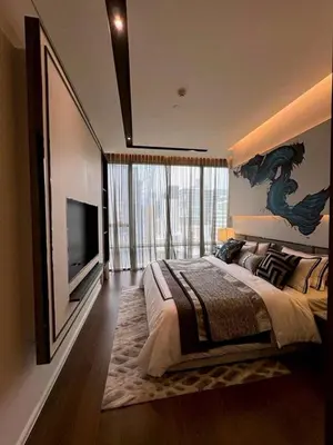 a bedroom with a large bed and a tv at The Bangkok Thonglor in Bangkok