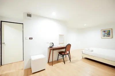 a bedroom with a bed and a desk with a chair at Snap Sukhumvit 1 - Bangkok City